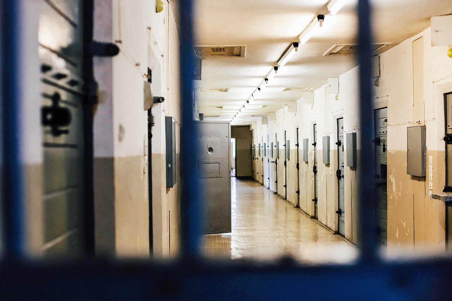 The inside of a prison, viewed through the bars.