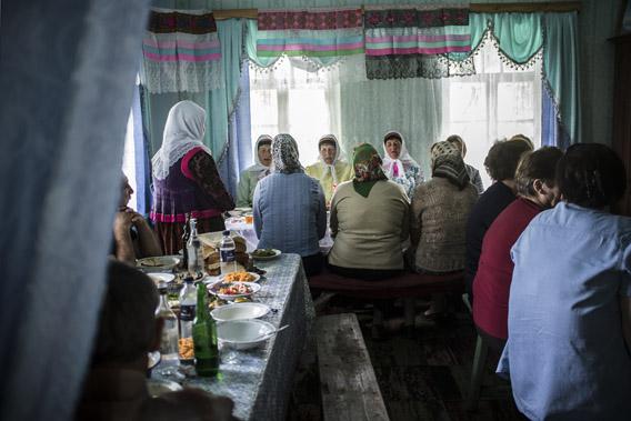 Doukhobor men and women gather to eat and pray, Gorelovka, Georgia. 