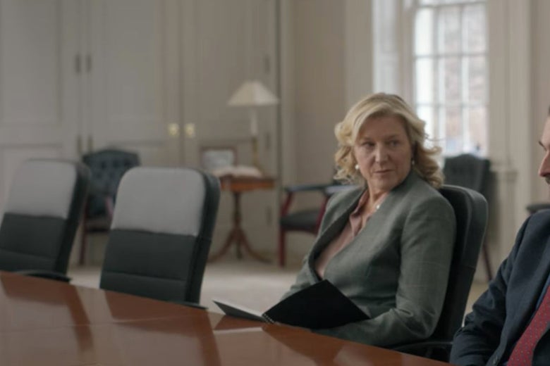 Bill's lawyer at a conference table with some fancy chairs behind her.