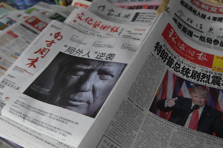 Chinese-language newspapers showing Trump's face