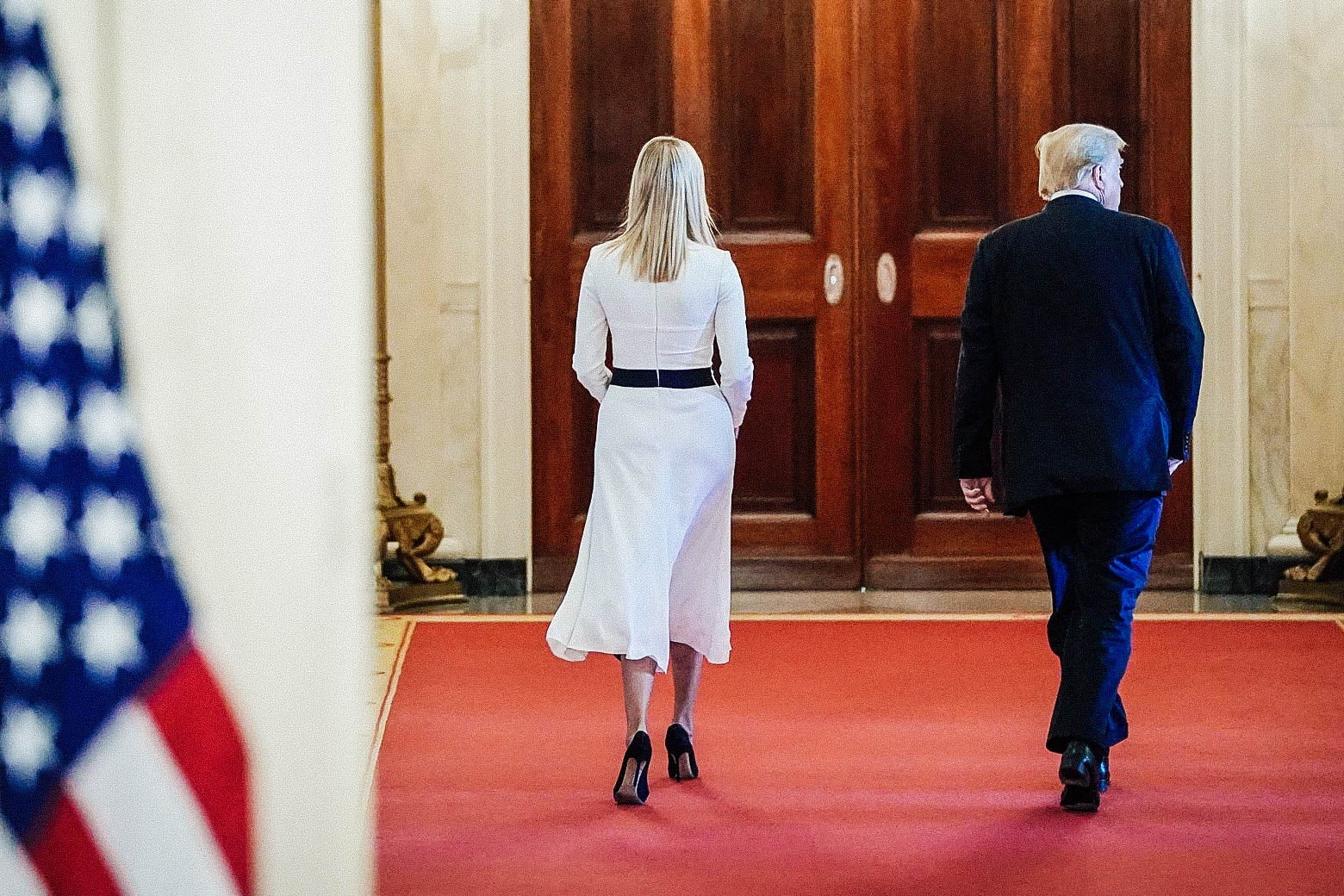 Ivanka Trump, walking down a hallway in the White House, with her father.