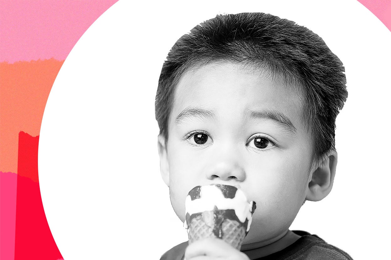 A young boy eats an ice cream cone.