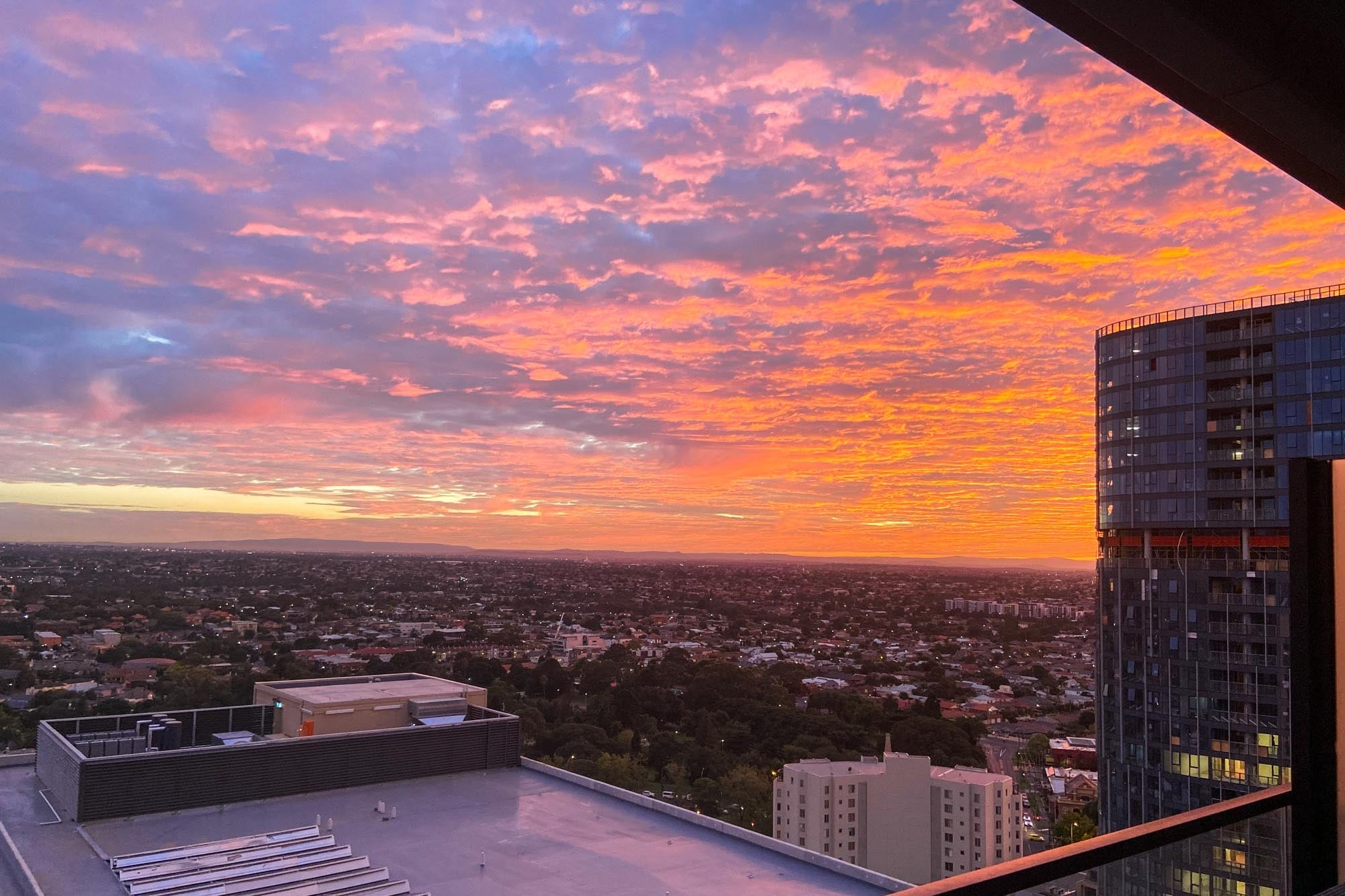 A vibrant sunset seen from a tall building