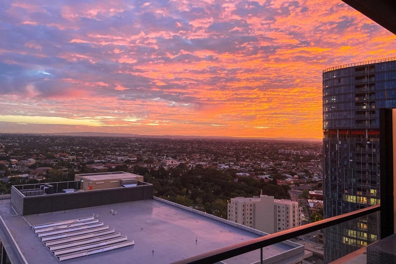 A vibrant sunset seen from a tall building