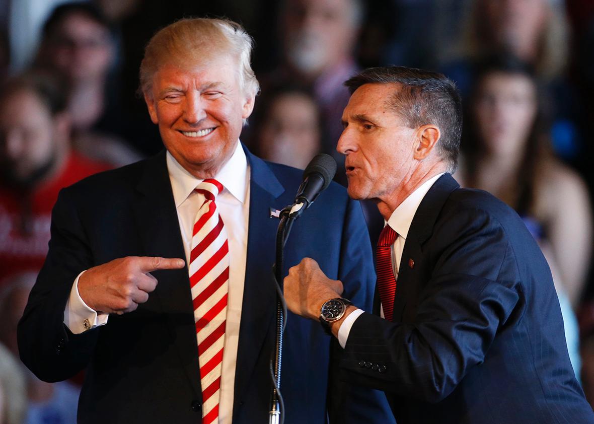 Republican presidential candidate Donald Trump jokes with retired Gen. Michael Flynn as they speak at a rally at Grand Junction Regional Airport on October 18, 2016 in Grand Junction Colorado.  