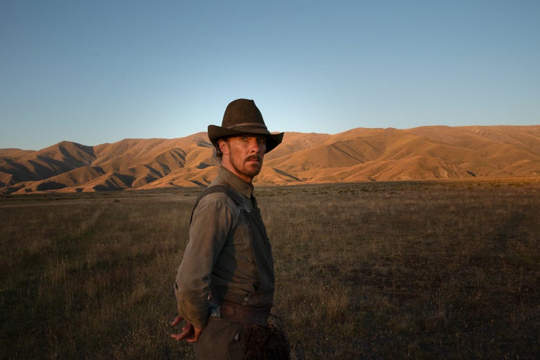 Benedict Cumberbatch, in a droopy cowboy hat, turning back in front of a Western vista, looking dirty