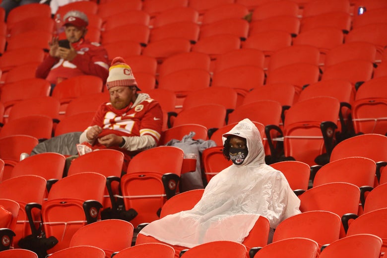 Kansas City Chiefs fans sit at halftime in the rain.