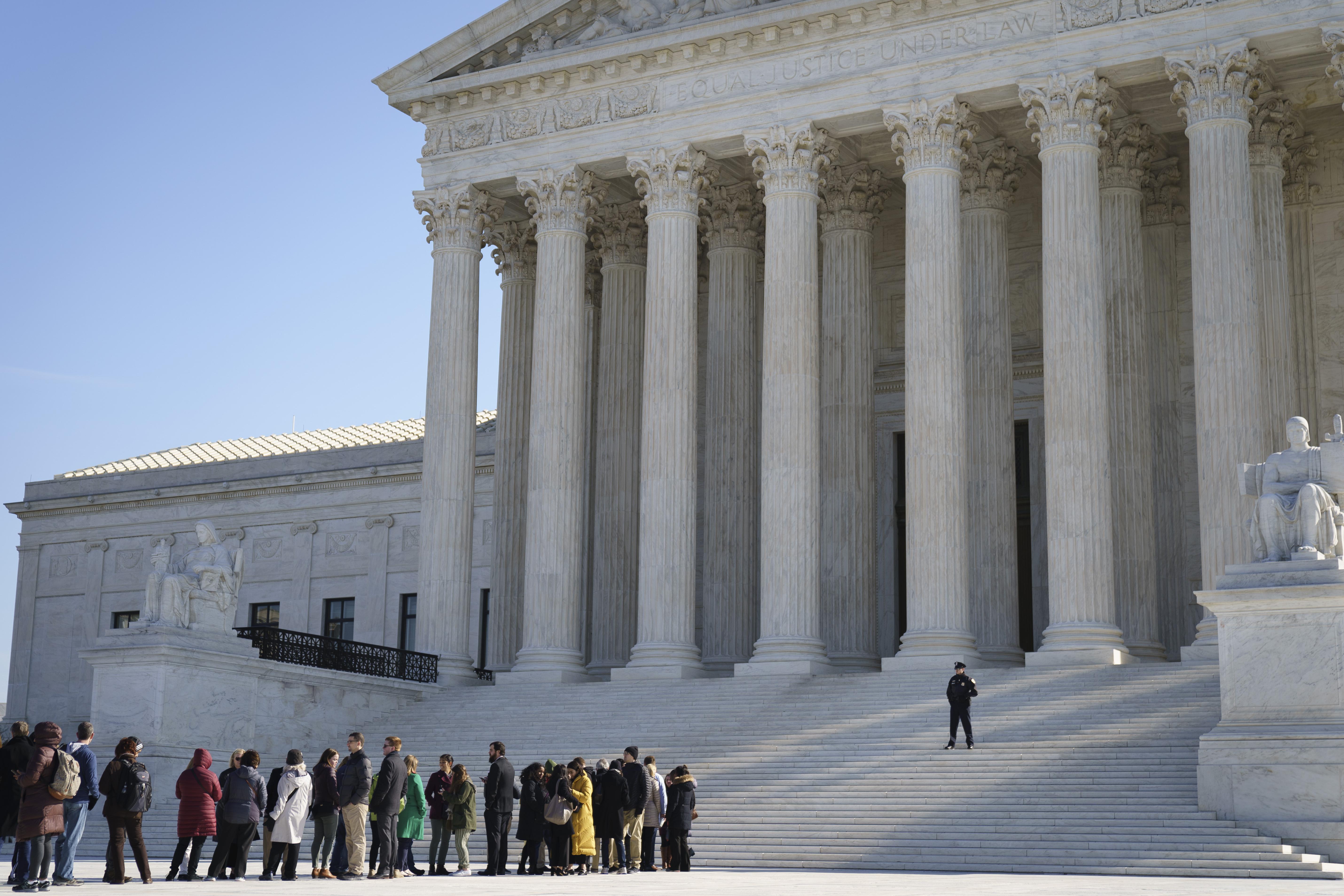 People wait in line to get into the Supreme Court