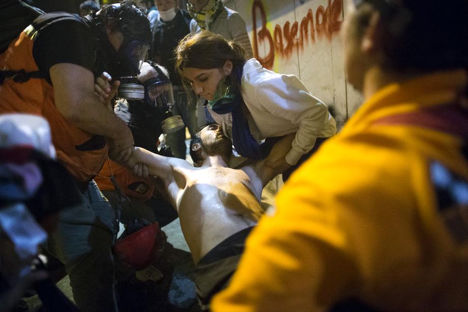 A medical team treats a protestor after he was injured by tear gas during clashes with Turkish police near Turkish prime minister Recep Tayyip Erdogan's office, early morning on June 4, 2013 in Istanbul.