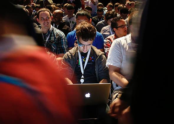 An attendee works on a computer during Google I/O Developers Conference.