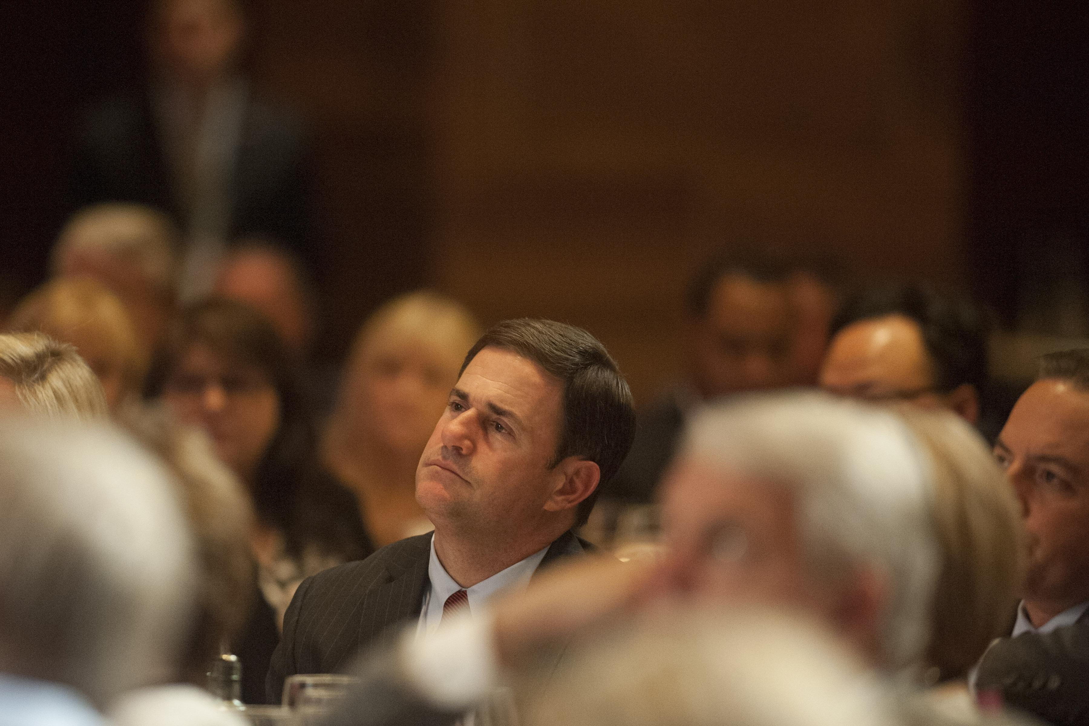 SCOTTSDALE, AZ  - MAY  14:  Arizona Gov. Doug Ducey listens as former Florida Gov. Jeb Bush speaks at a dinner during the Republican National Committee Spring Meeting  at The Phoenician  May 14, 2015 in Scottsdale, Arizona. Bush, brother of former President George W. Bush and son of former President George H.W. Bush, is widely expected to run for the Republican nomination for president in 2016.  (Photo by Laura Segall/Getty Images)