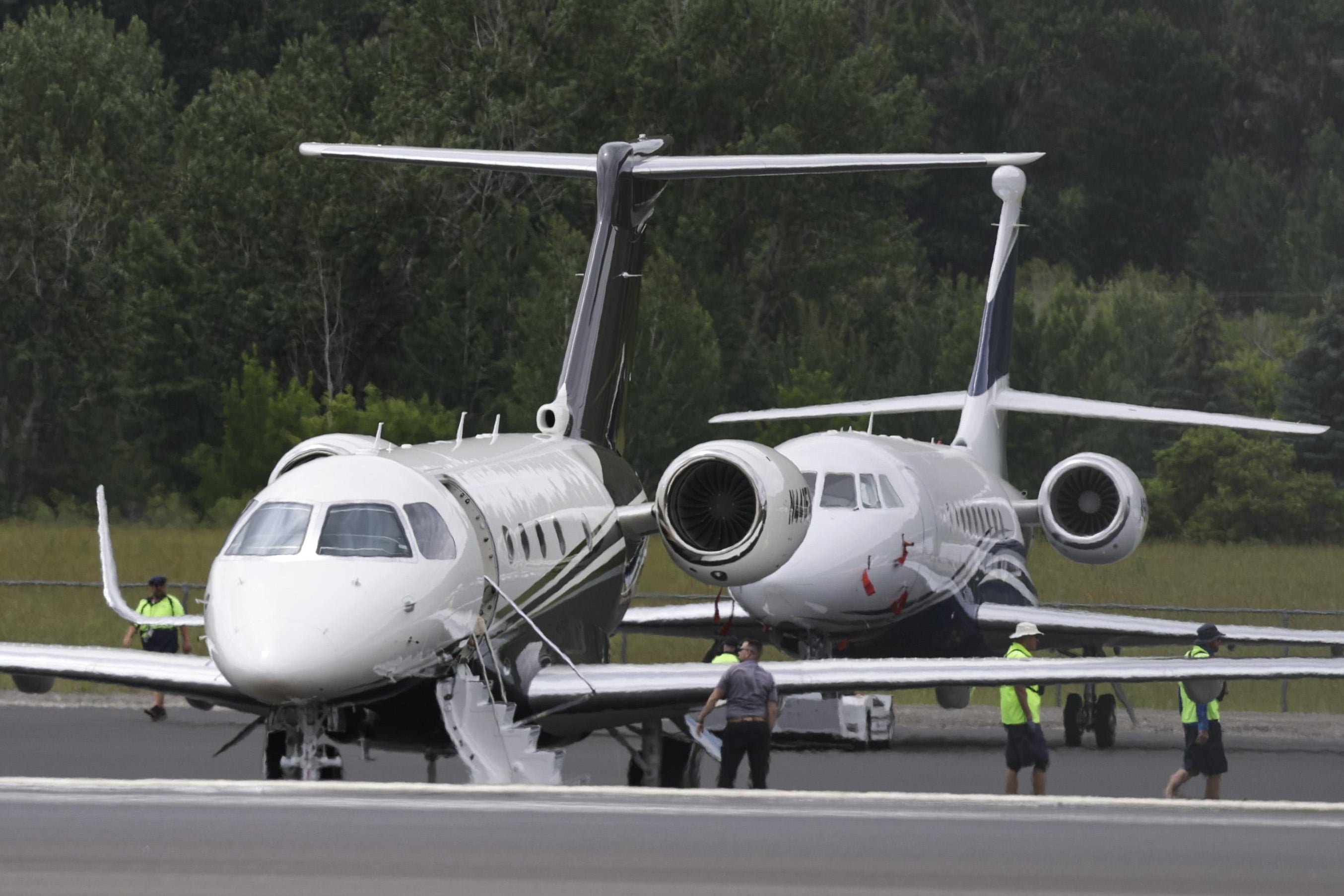 Two private jets are seen on tarmac