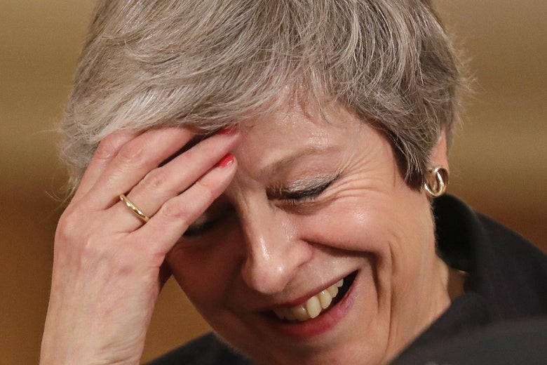 Britain's Prime Minister Theresa May laughs as she speaks during a press conference inside 10 Downing Street on November 15, 2018.