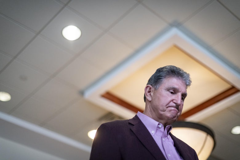 Sen. Joe Manchin (D-WV) is interviewed after a news conference at the Marriott Hotel at Waterfront Place June 3, 2021 in Morgantown, West Virginia. Manchin looks down with a big Bill Cinton-esque bite lip going.