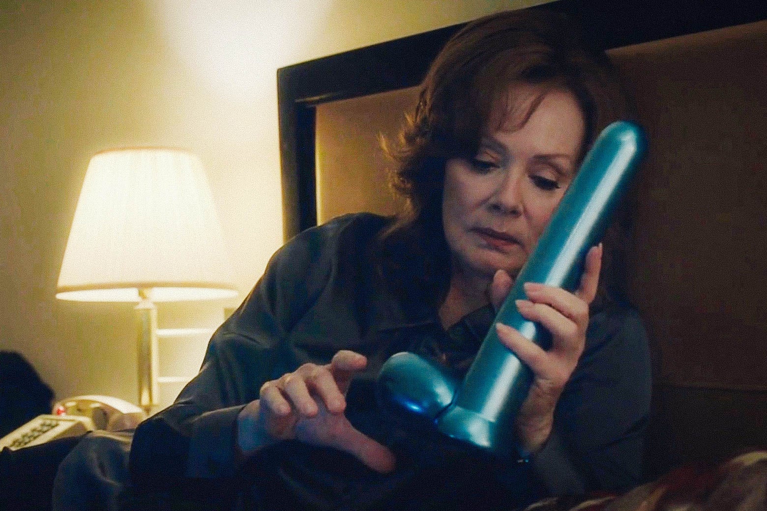 Jean Smart holds a shiny blue dildo in a scene from HBO’s Watchmen.