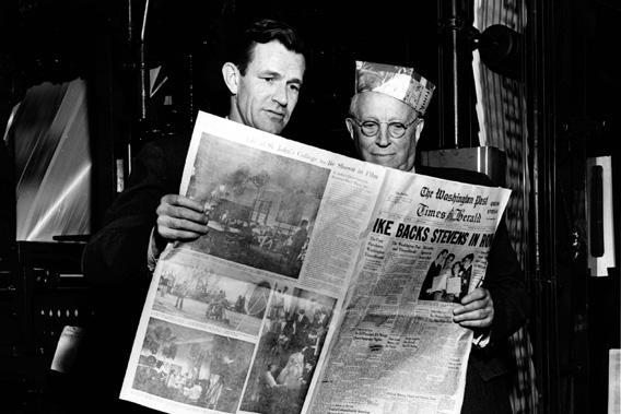 Philip L. Graham and Eugene Meyer hold a copy of The Washington Post, on March 18, 1954.