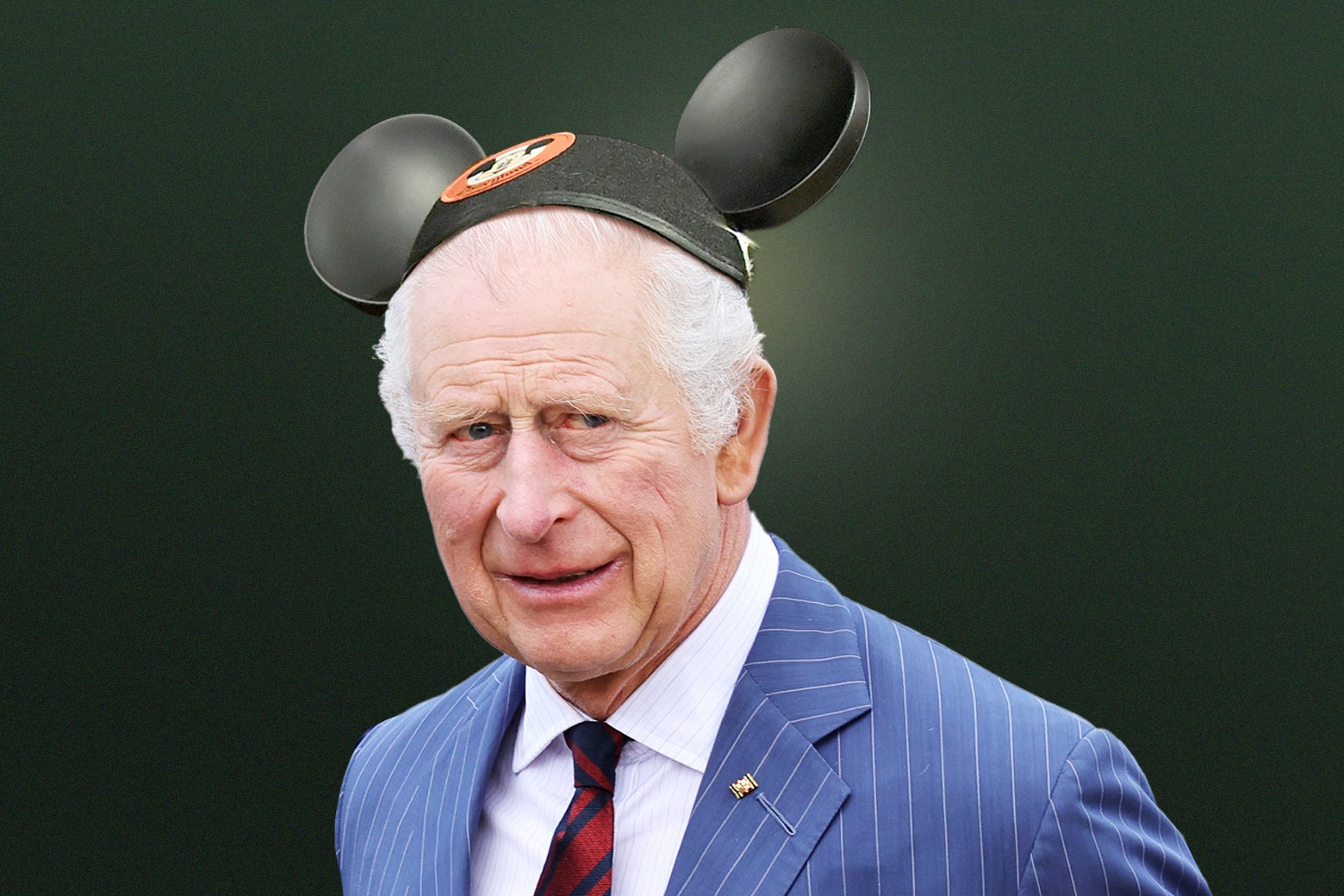 A photo of King Charles, altered to show him wearing Mickey Mouse ears.