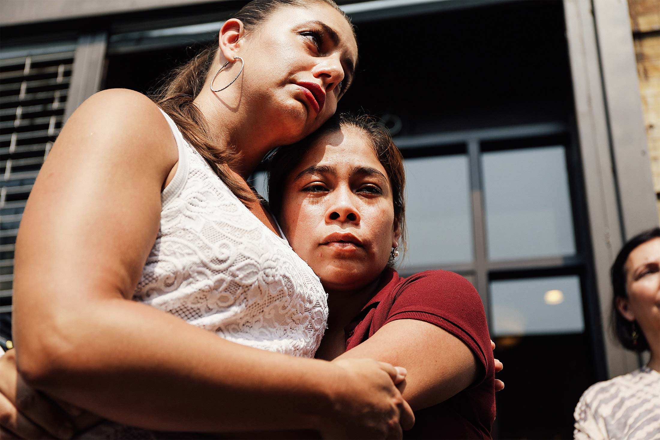 Janey Pearl stands with Yeni Maricela Gonzalez Garcia as she speaks with the news media following a visit with her children at the East Harlem Cayuga Centers on July 3 in New York City.