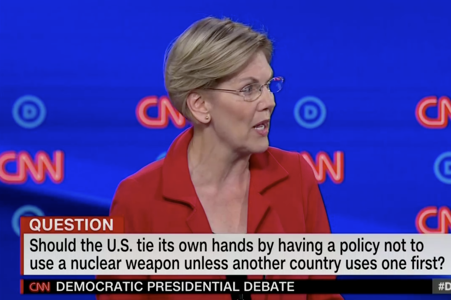 In this screengrab from CNN, Elizabeth Warren debates. The banner reads: "Should the U.S. tie its own hands by having a policy not to use a nuclear weapon unless another country uses one first?"
