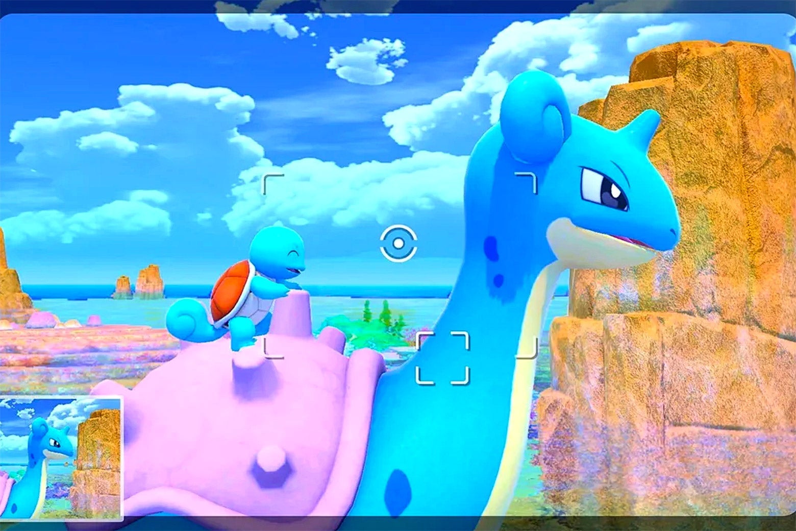 A blue turtle-like monster sits atop a blue monster with a horn and purple shell. There are clouds and a blue sky behind them, as well as a brownish peak.