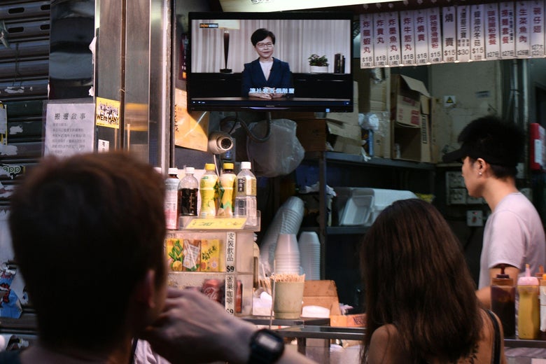 Customers at an eatery watch a live television broadcast showing Hong Kong Chief Executive Carrie Lam formally withdrawing a controversial extradition bill in Hong Kong on September 4, 2019. 