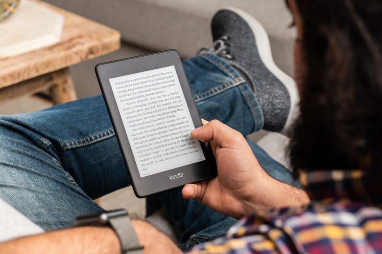 Man holding an Amazon Kindle