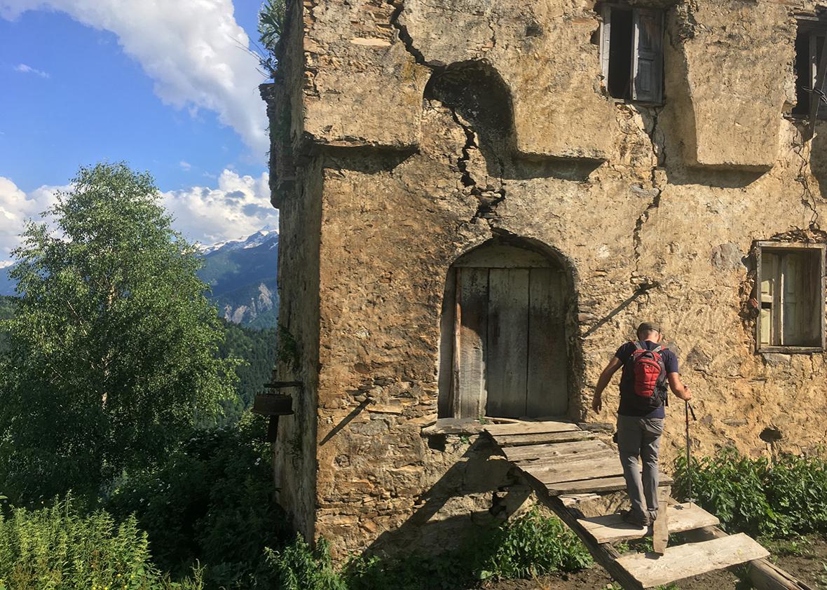 Austin Cowley explores a crumbling koshki beside the home of Nino in Svaneti, Georgia.