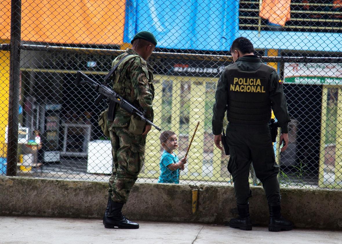 A soldier and a police officer enforce the truce with the FARC in Gaitania much to the discomfort of many of the village’s residents. 