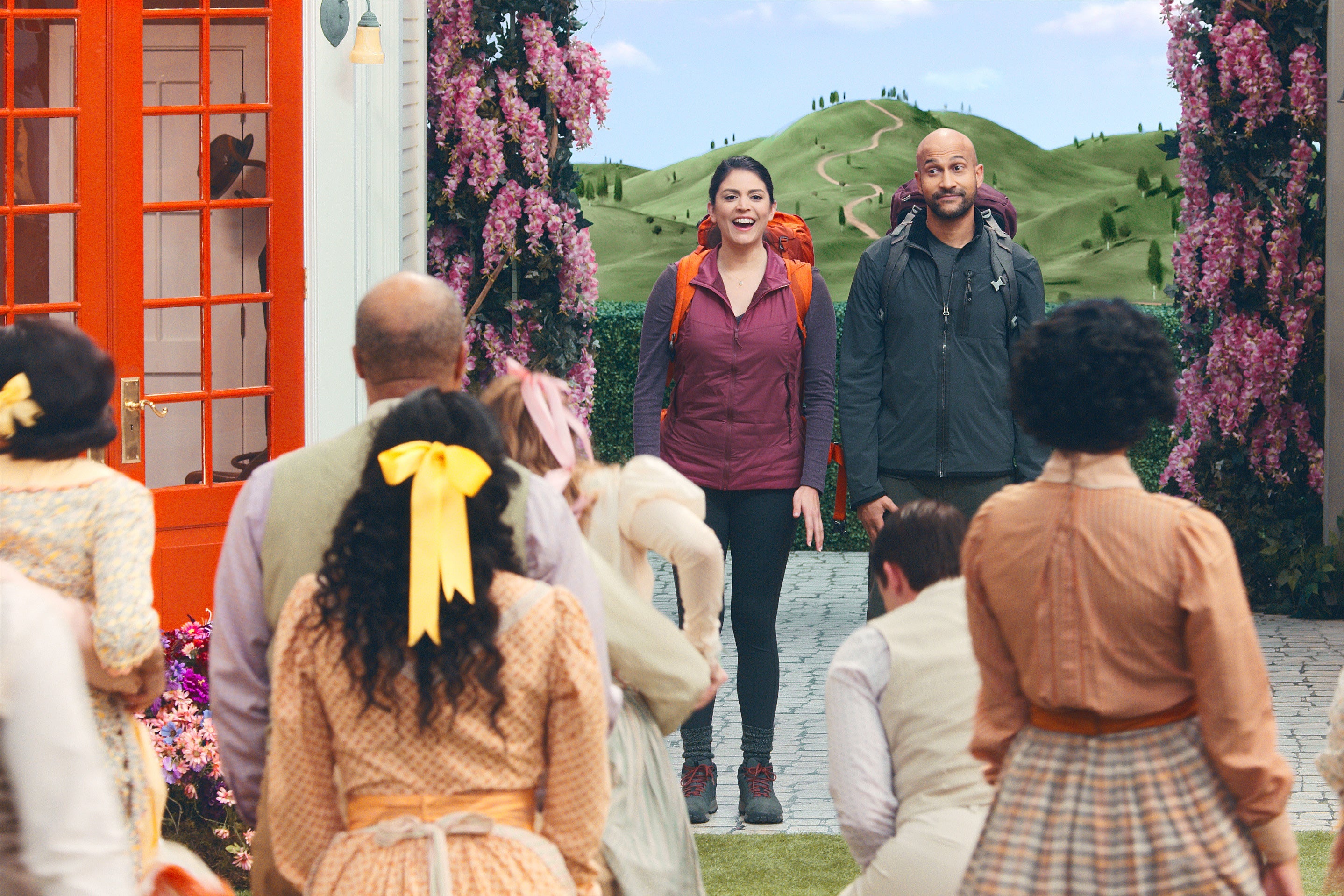 cecily strong and keegan-michael key survey a group of costumed performers