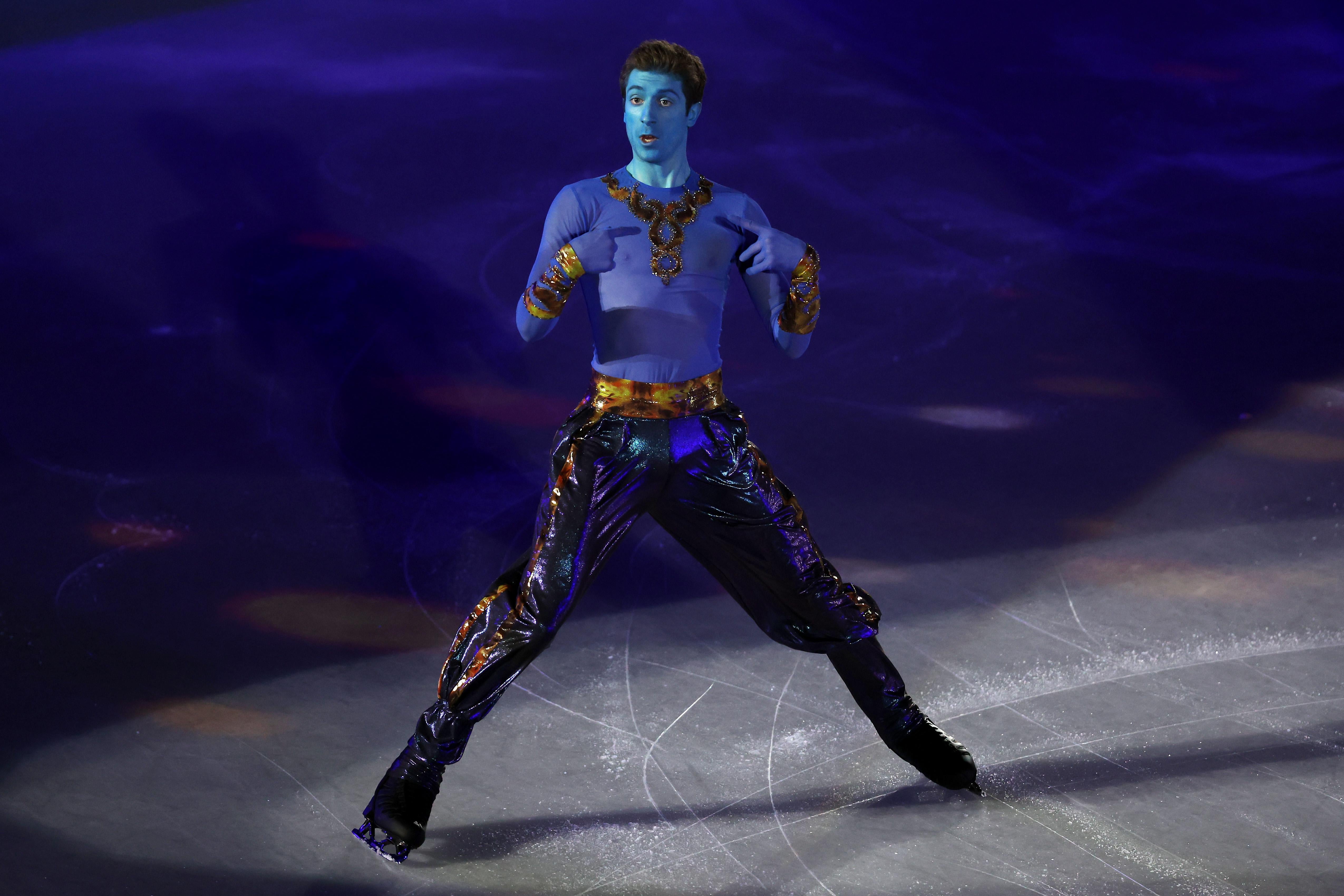 Kvitelashvili dressed as the blue genie from Aladdin skating on the ice