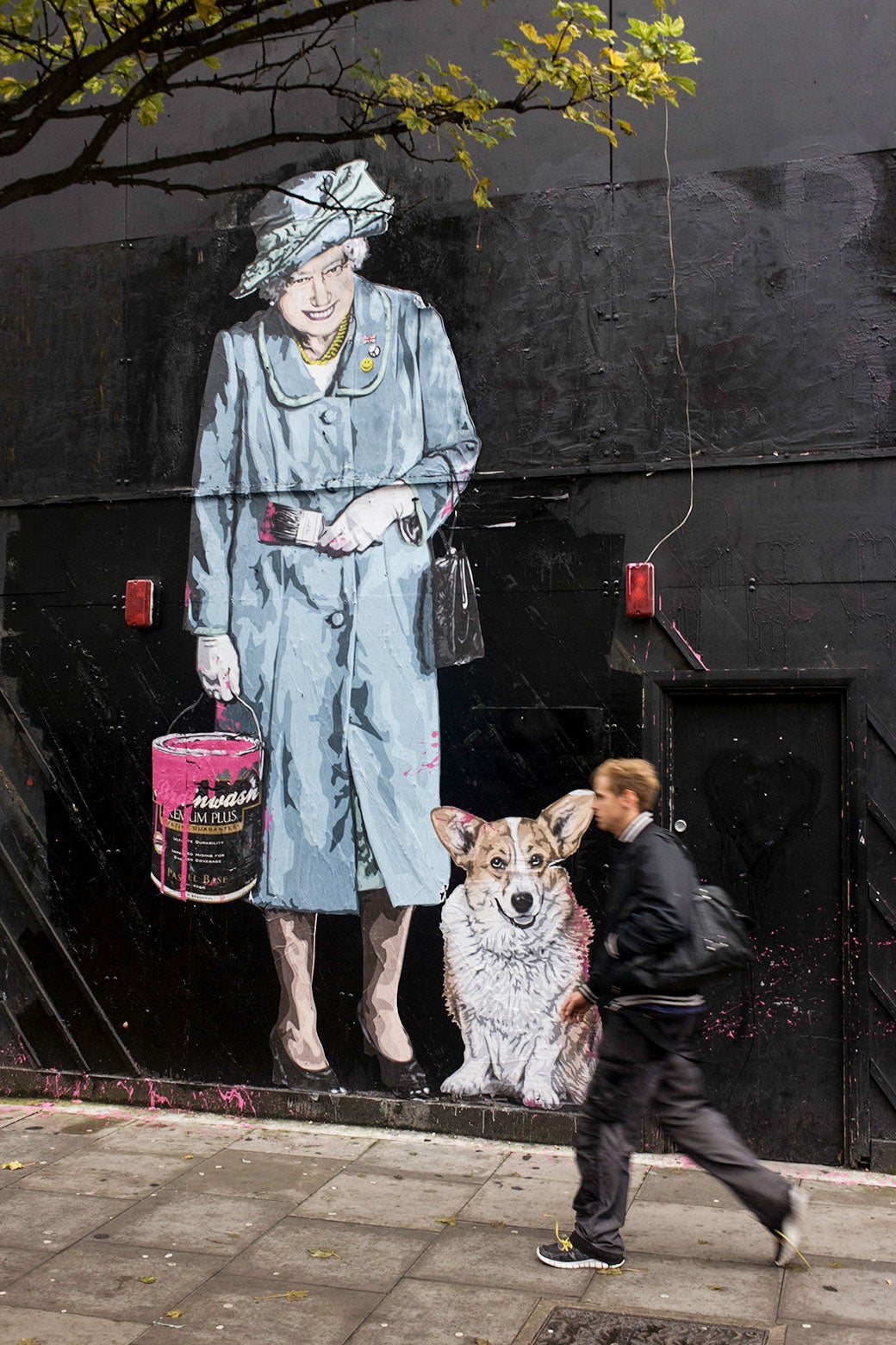 A mural of Queen Elizabeth with a corgi. 
