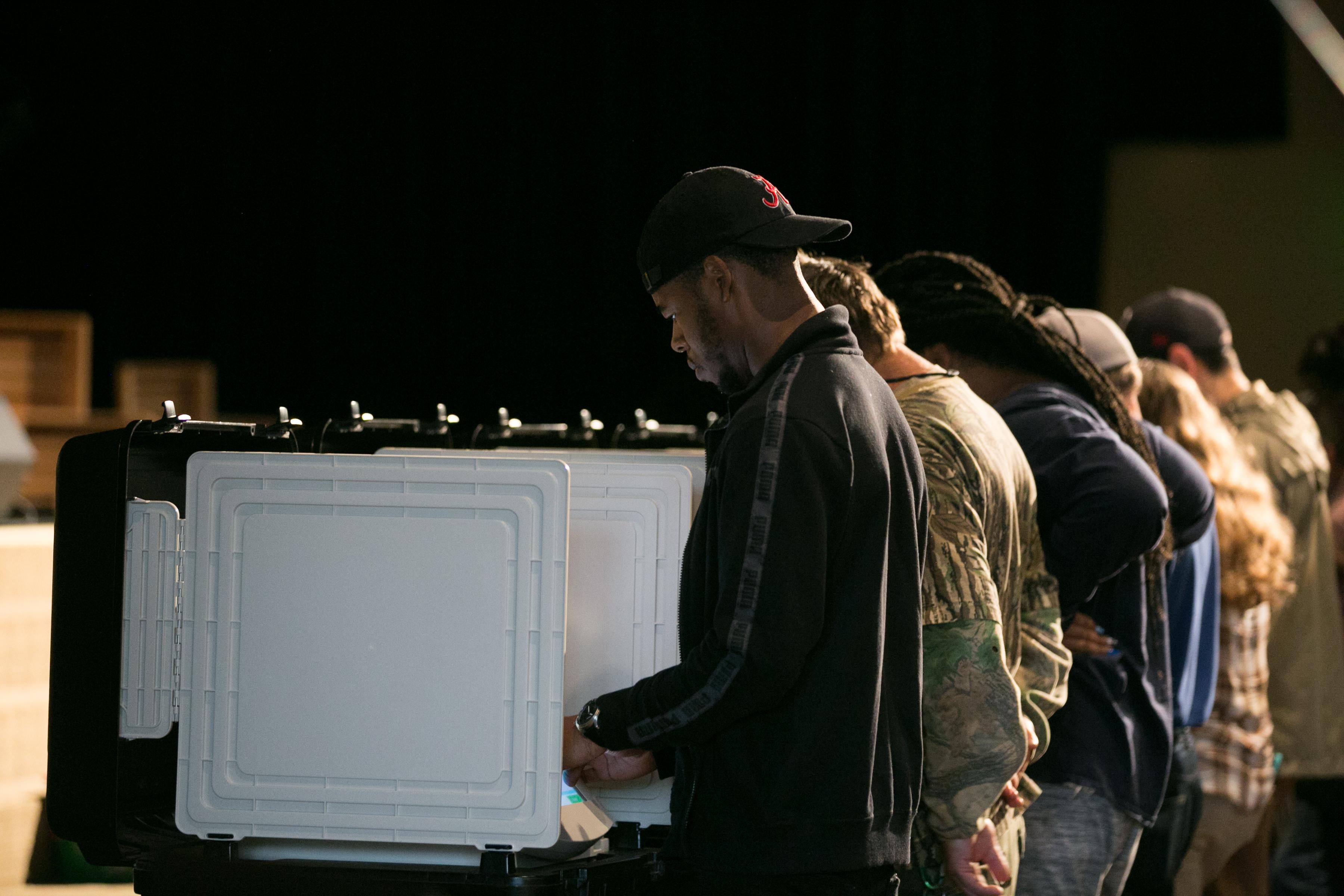 Voters cast their ballots in a polling place.
