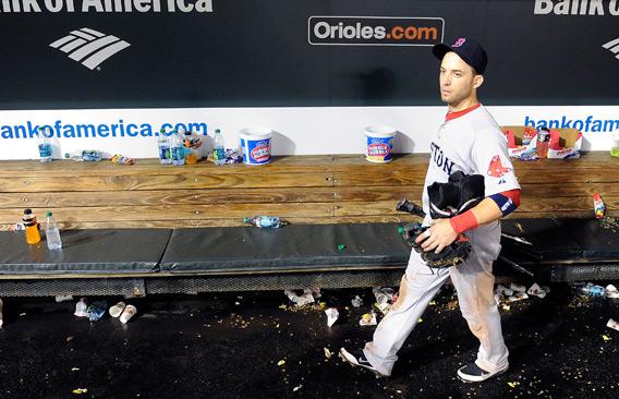 Marco Scutaro, No. 10 of the Boston Red Sox, walks in the dugout after a 4-3 loss against the Baltimore Orioles.