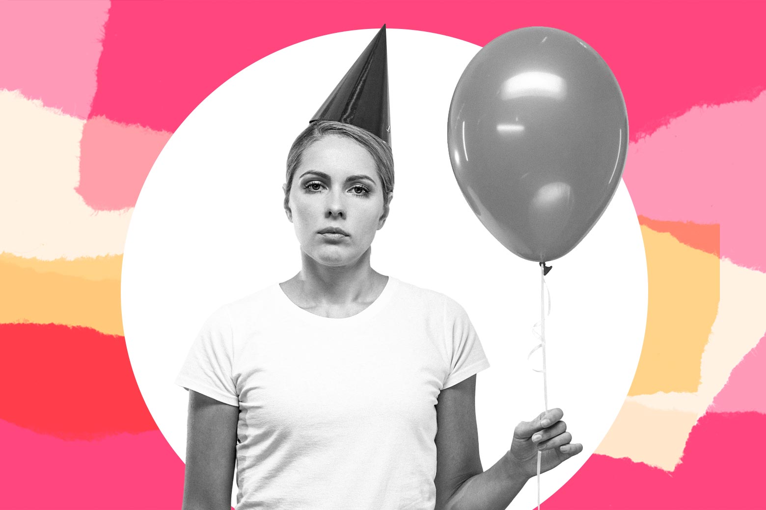 An annoyed looking woman holds a balloon.