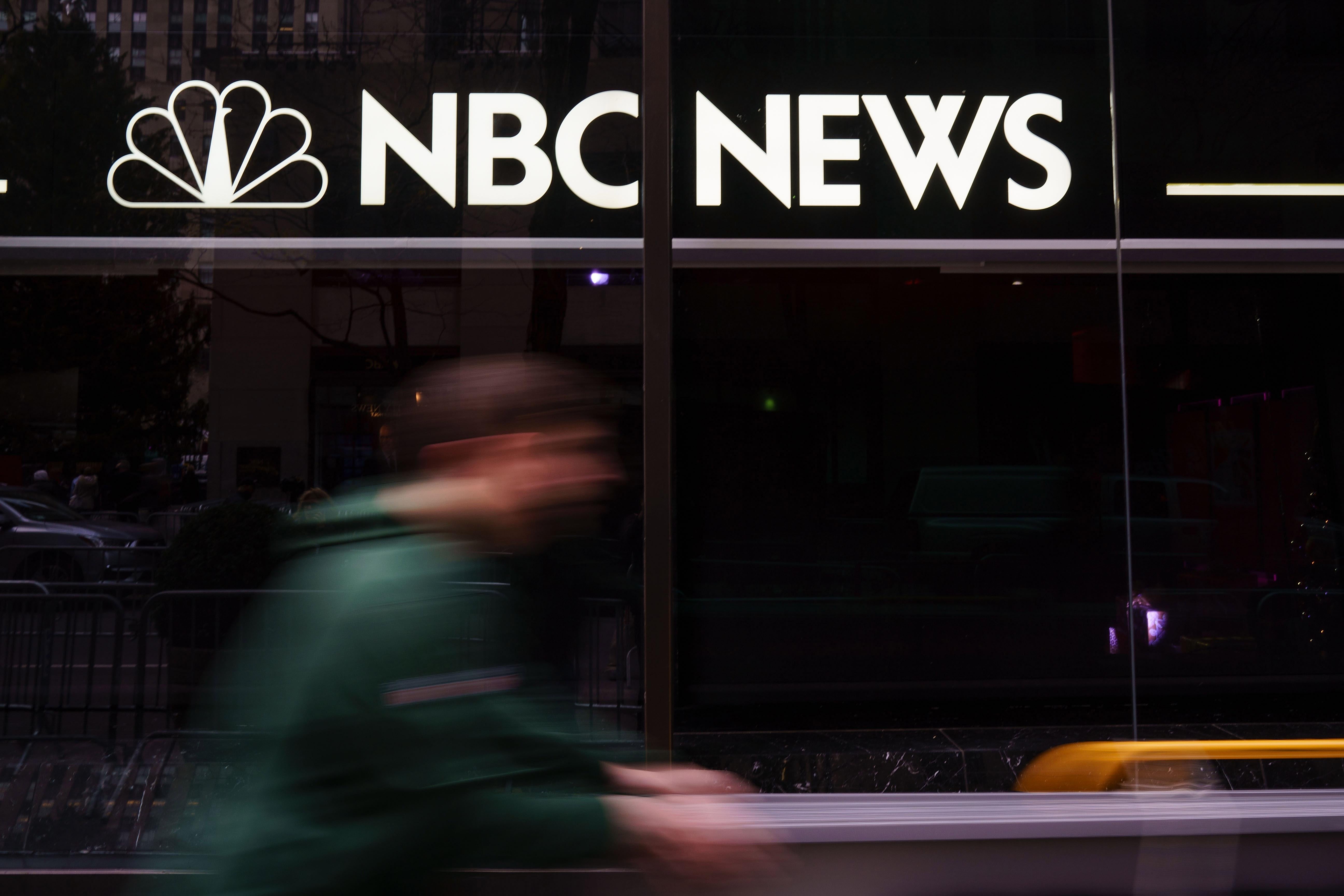 A pedestrian walks past the NBC News studios.