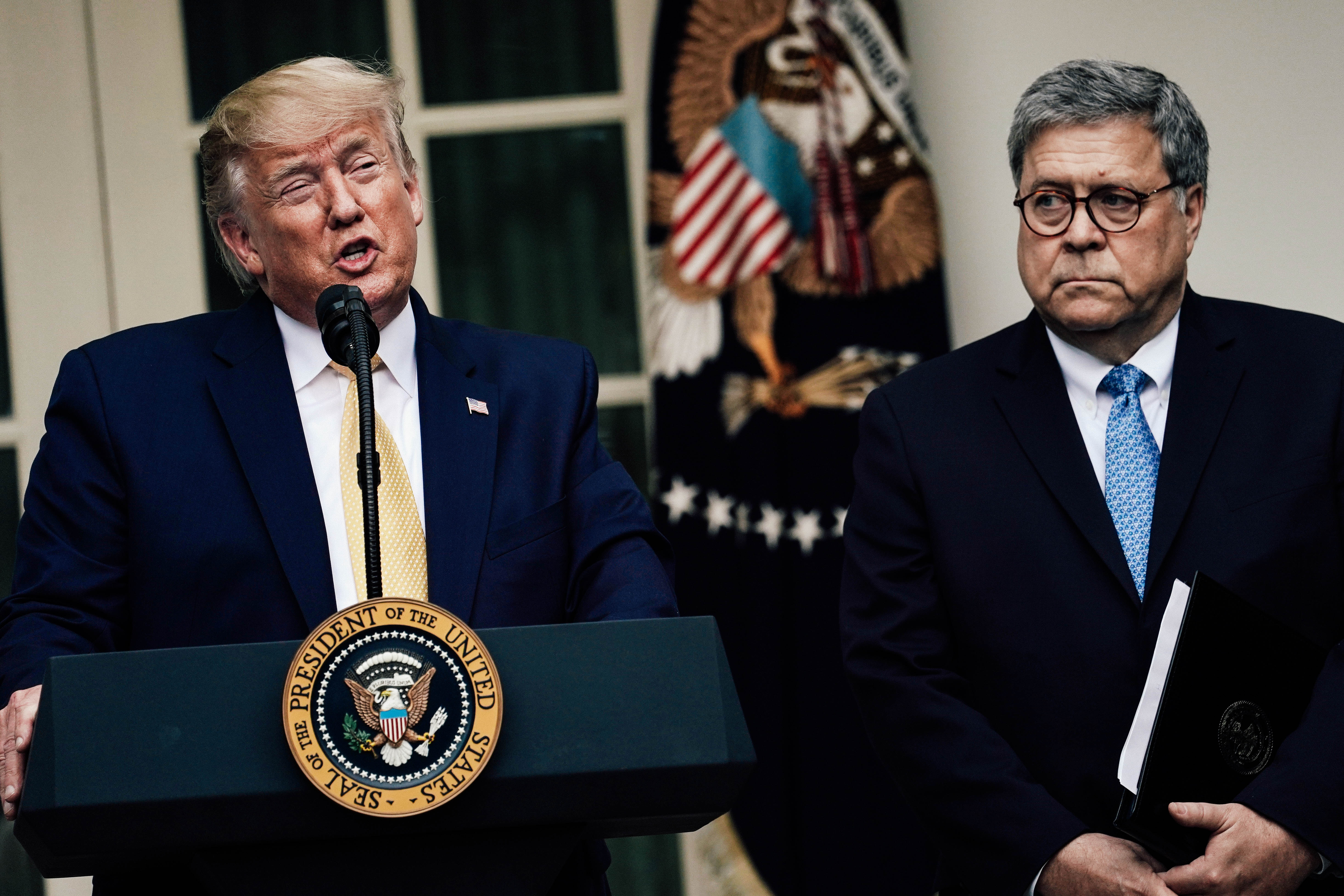 President Donald Trump makes a statement with Attorney General William Barr.