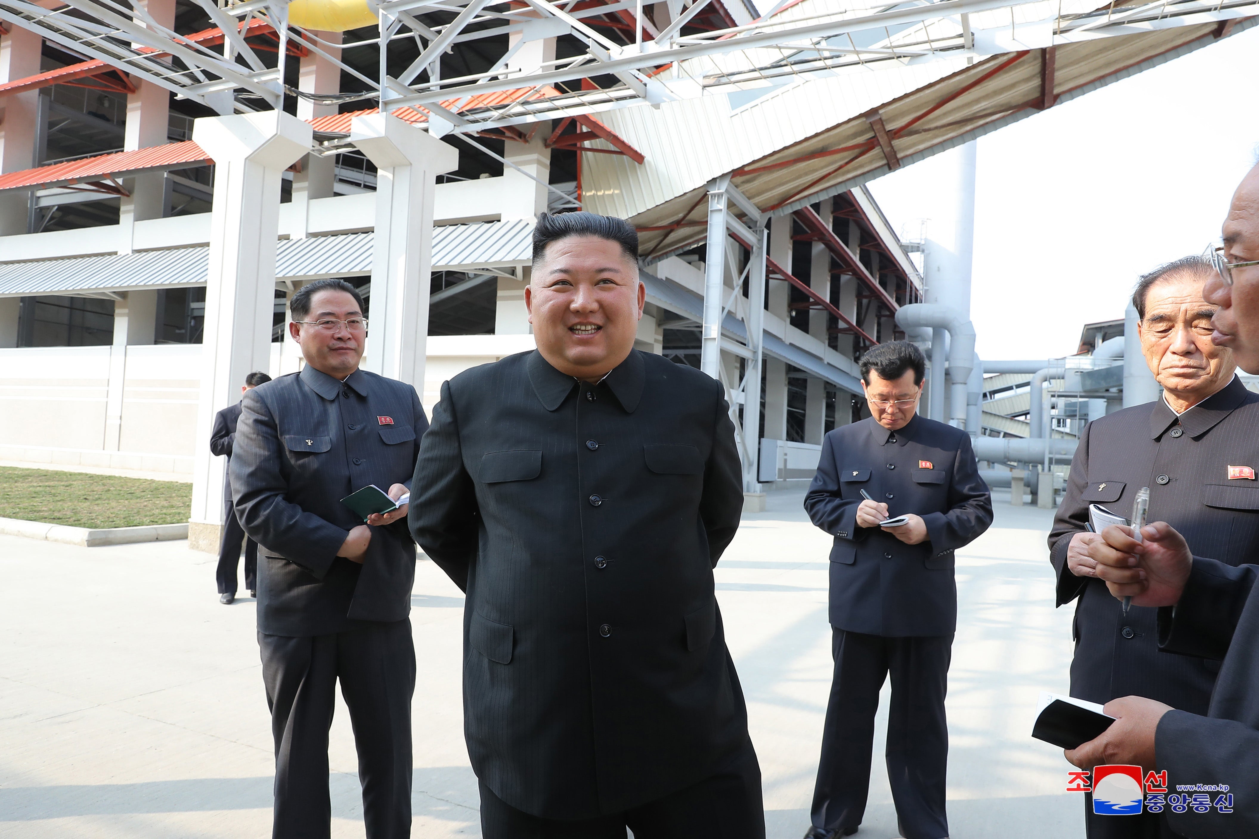 Kim Jong-un and senior officials touring a factory.