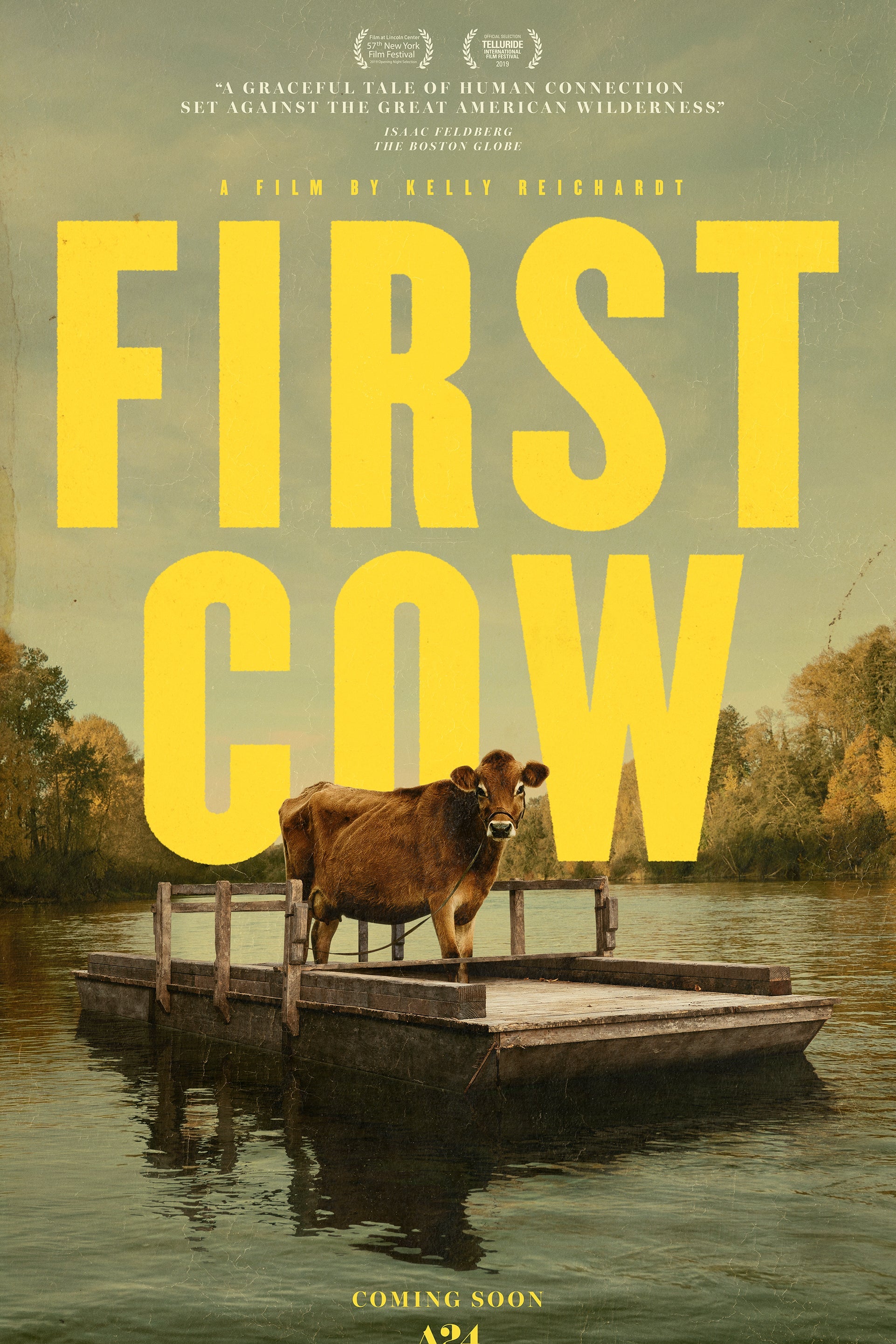 First Cow movie poster. Eve stands on a raft over calm waters, looming in front of the words "First Cow."