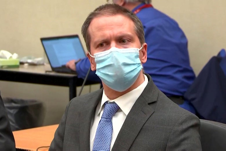 Derek Chauvin, wearing a blue mask, listens in the courtroom as a jury finds him guilty of all charges.