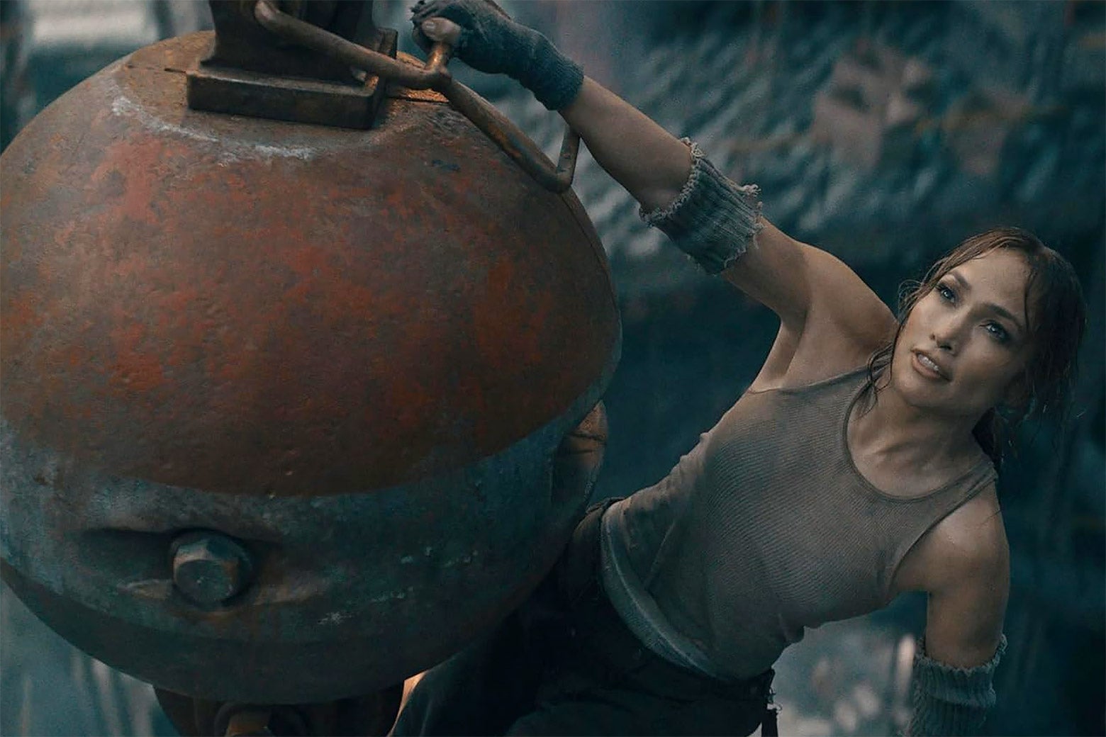 Jennifer Lopez hanging from a metal wrecking ball.