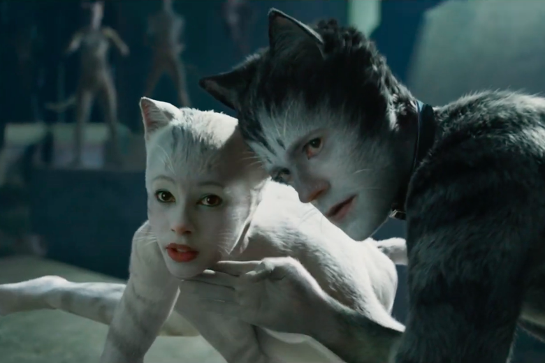 Two actors in cat costumes.