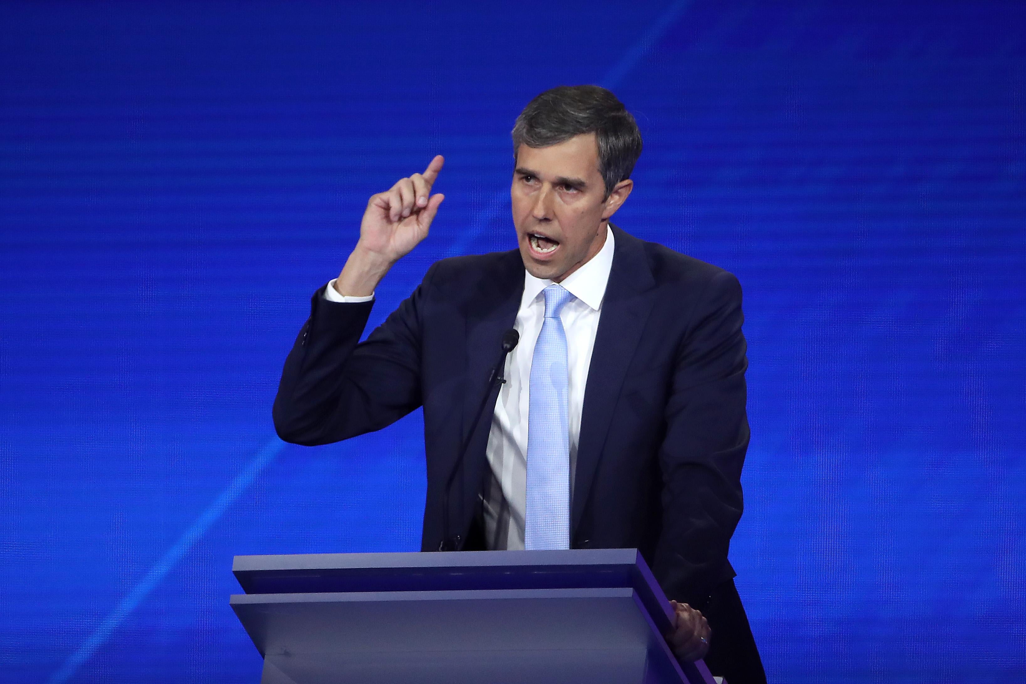 Beto O'Rourke raises his hand as he speaks during the debate.