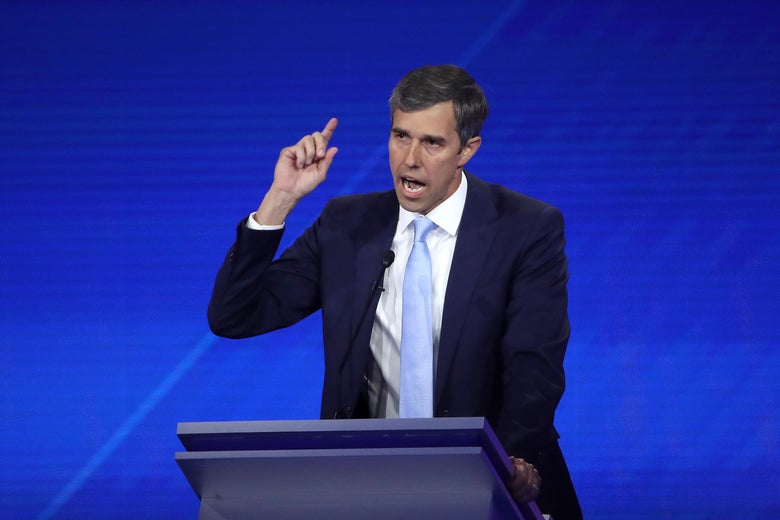 Beto O'Rourke raises his hand as he speaks during the debate.