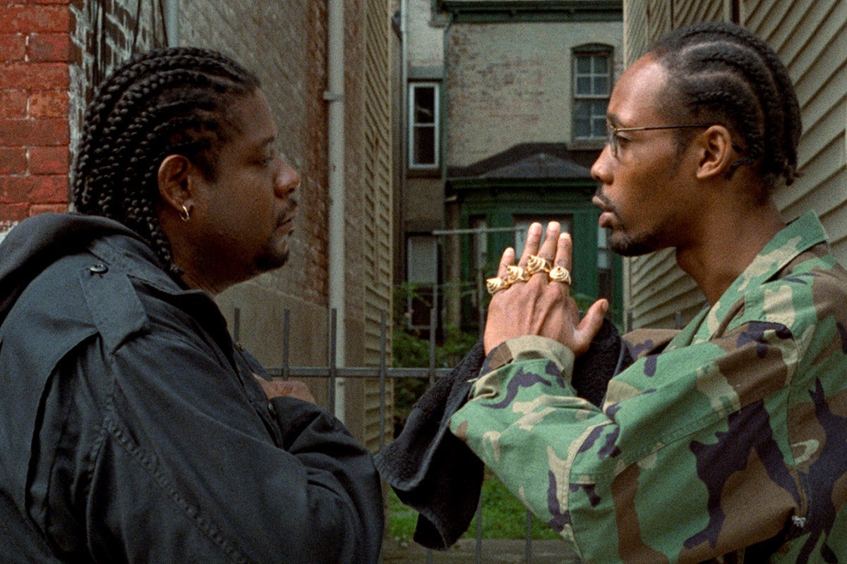 Forrest Whitaker and RZA look at each other, in profile, in a movie still.