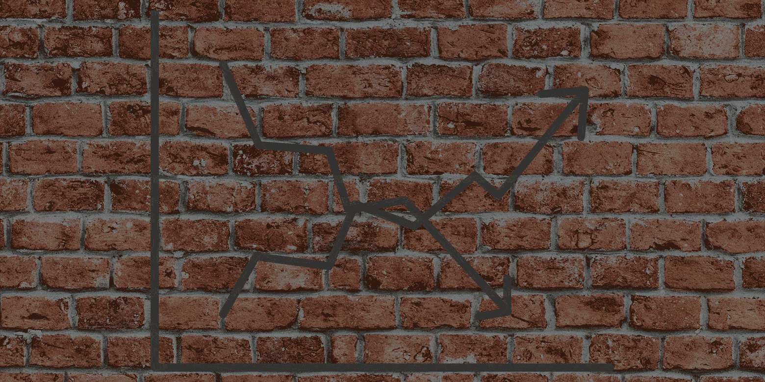 brick wall with neon arrows pointing up and down