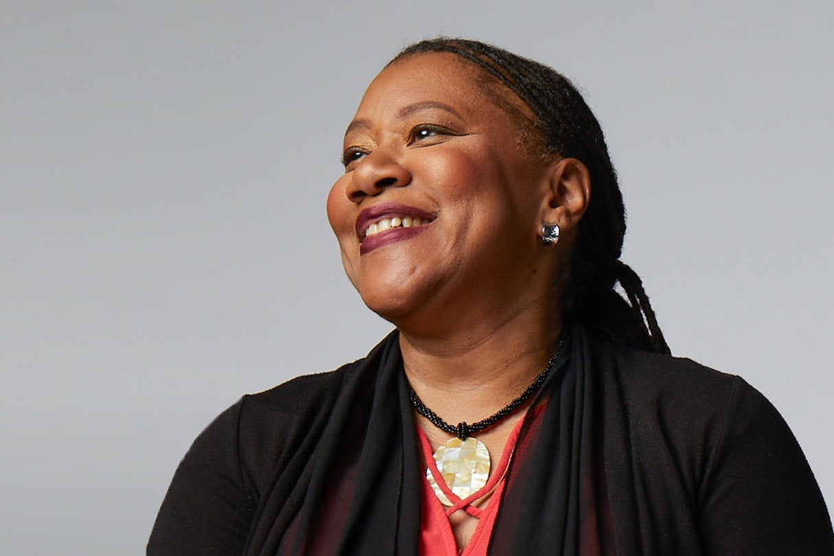 A portrait of journalist Rose Scott, looking up and smiling