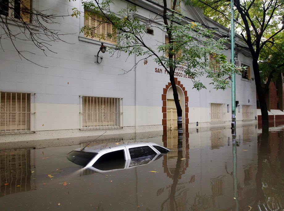 A submerged car is seen in a flooded street after a rainstorm in Buenos Aires on April 2, 2013.