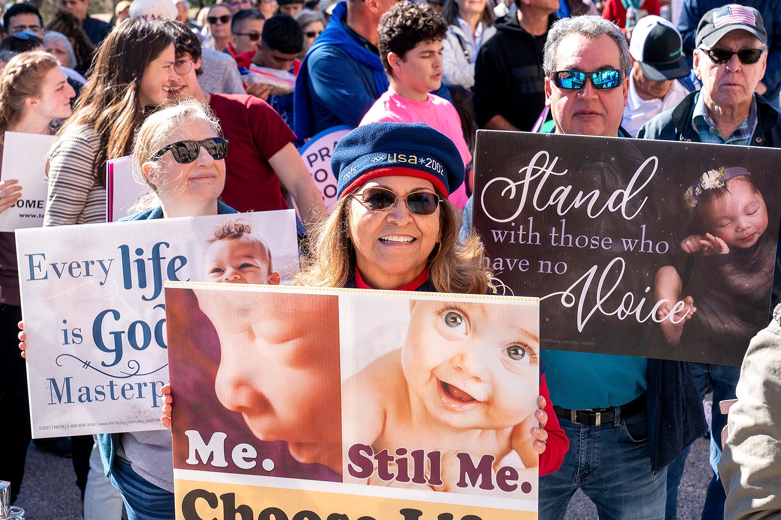 Pro-life supporters take part in a Rally for Life march outside the Texas State Capitol on Jan. 27 in Austin, Texas, holding signs showing babies and fetuses.