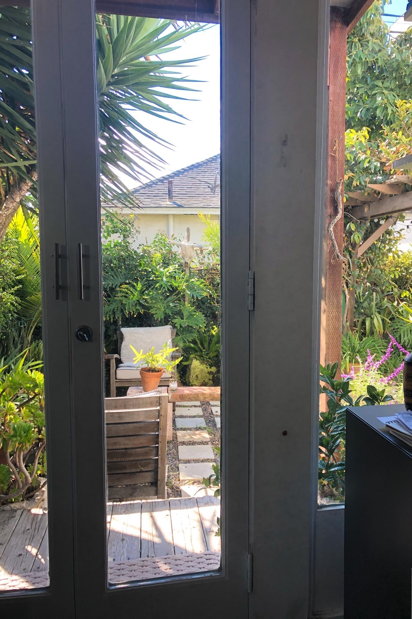 View of a lush backyard from a kitchen window.