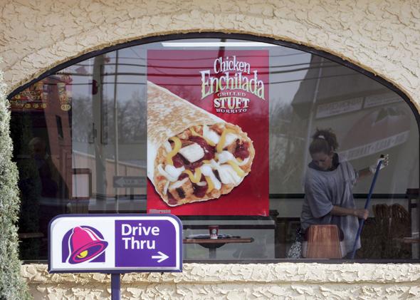 A woman cleans a Taco Bell